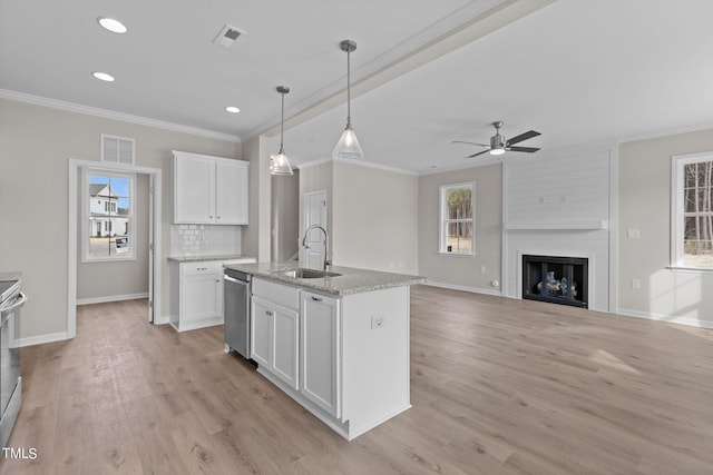 4529 Sweet Williams Ln, Wilson, NC 27896 - kitchen featuring a sink, crown molding, stainless steel appliances, white cabinets, and light wood finished floors