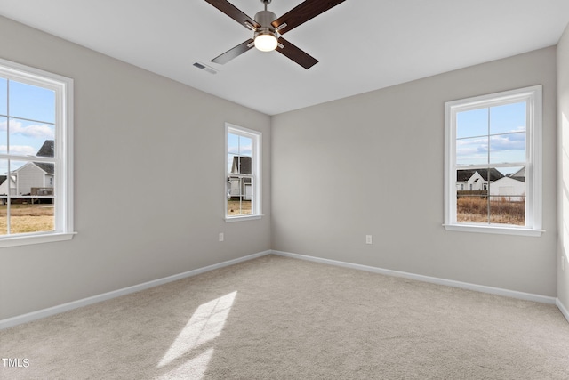 4529 Sweet Williams Ln, Wilson, NC 27896 - spare room with a ceiling fan, healthy amount of natural light, and carpet floors