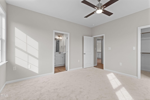 4529 Sweet Williams Ln, Wilson, NC 27896 - unfurnished bedroom featuring carpet flooring, a walk in closet, baseboards, and connected bathroom
