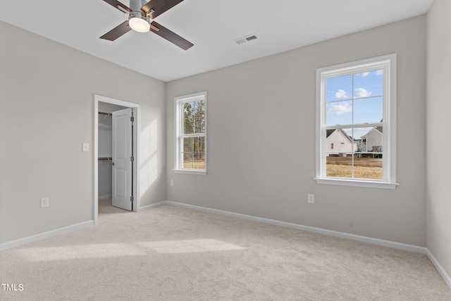 4529 Sweet Williams Ln, Wilson, NC 27896 - unfurnished bedroom featuring carpet floors, baseboards, a walk in closet, ceiling fan, and a closet