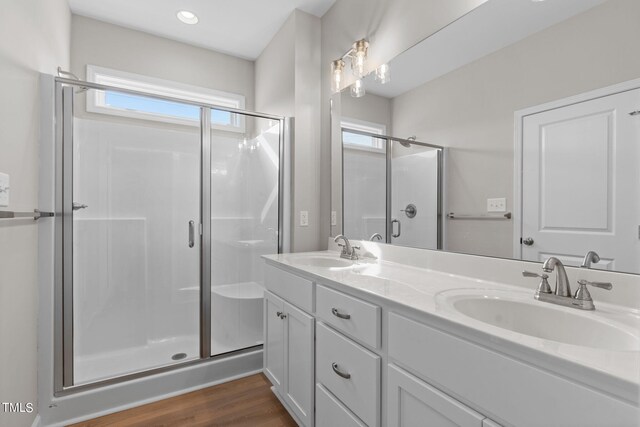 4529 Sweet Williams Ln, Wilson, NC 27896 - full bathroom featuring a stall shower, double vanity, plenty of natural light, and wood finished floors