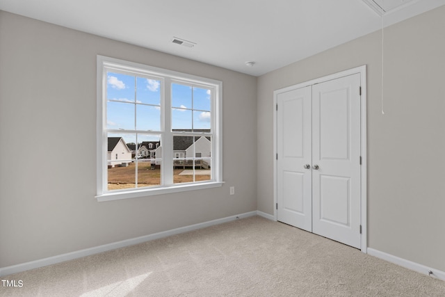 4529 Sweet Williams Ln, Wilson, NC 27896 - unfurnished bedroom featuring carpet flooring, baseboards, attic access, and a closet