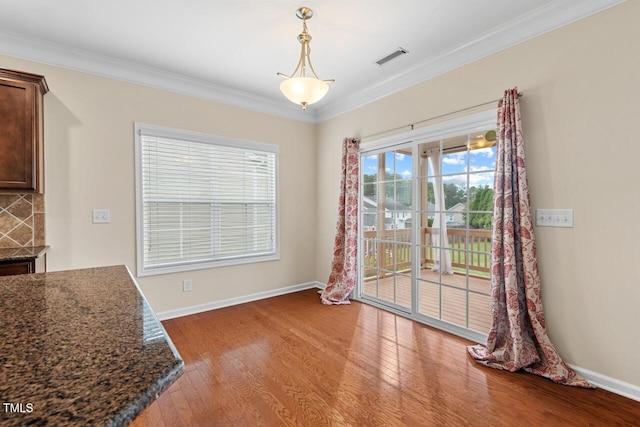 210 Strolling Way, Durham, NC 27707 - unfurnished dining area featuring wood finished floors, crown molding, and baseboards