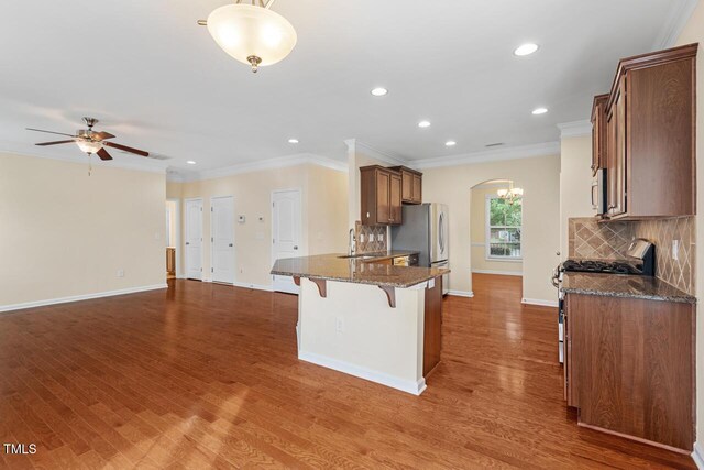 210 Strolling Way, Durham, NC 27707 - kitchen featuring appliances with stainless steel finishes, a sink, a breakfast bar area, recessed lighting, and baseboards