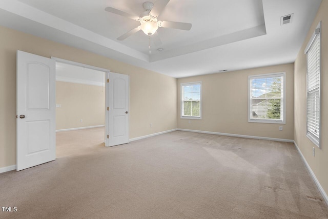 210 Strolling Way, Durham, NC 27707 - empty room with a tray ceiling, carpet floors, healthy amount of natural light, and baseboards