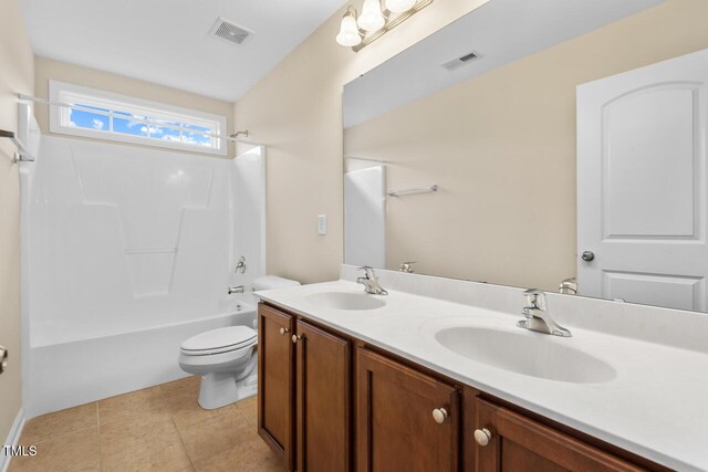 210 Strolling Way, Durham, NC 27707 - bathroom with toilet, double vanity, bathtub / shower combination, and tile patterned floors