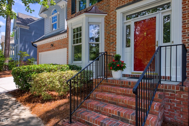 405 Widdington Ln, Cary, NC 27519 - doorway to property with brick siding and a garage