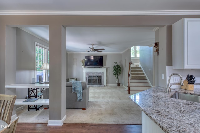 405 Widdington Ln, Cary, NC 27519 - living room with plenty of natural light, crown molding, a fireplace, and wood finished floors
