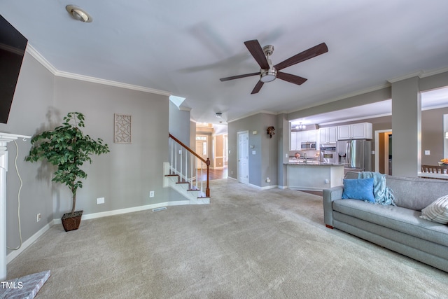 405 Widdington Ln, Cary, NC 27519 - living room featuring ceiling fan, stairs, light carpet, and ornamental molding