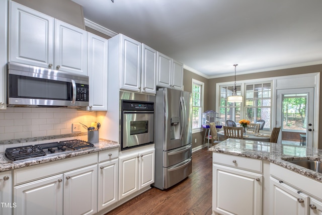 405 Widdington Ln, Cary, NC 27519 - kitchen featuring stainless steel appliances, ornamental molding, dark wood-type flooring, white cabinets, and tasteful backsplash