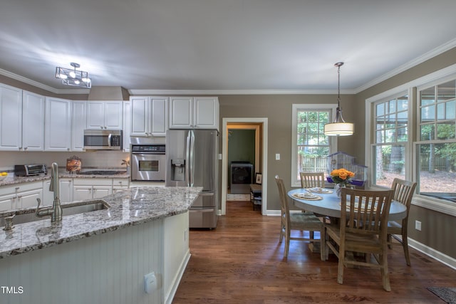 405 Widdington Ln, Cary, NC 27519 - kitchen featuring stainless steel appliances, dark wood-style flooring, white cabinetry, decorative light fixtures, and light stone counters