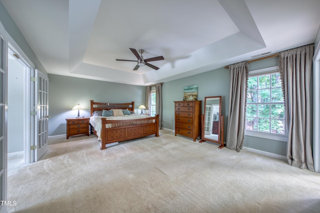 405 Widdington Ln, Cary, NC 27519 - bedroom featuring a raised ceiling, multiple windows, light carpet, and ceiling fan