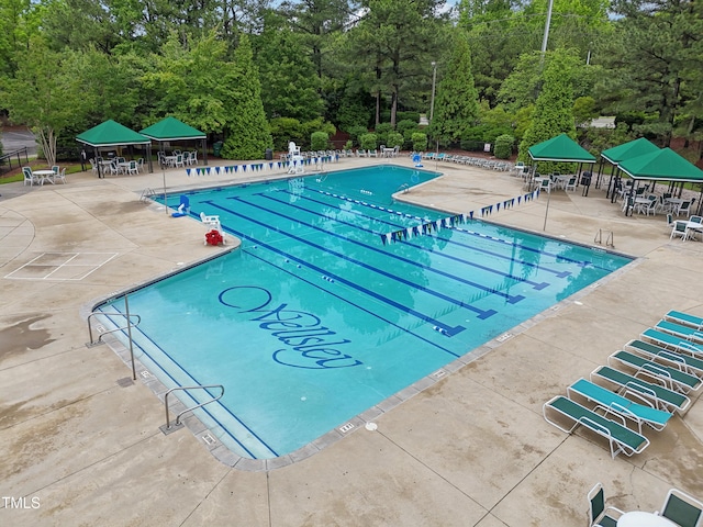 405 Widdington Ln, Cary, NC 27519 - community pool featuring a patio and view of scattered trees