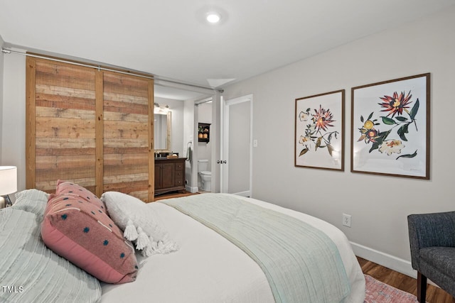 106 Choptank Ct Unit B-2, Cary, NC 27513 - bedroom featuring wood finished floors, baseboards, and ensuite bathroom