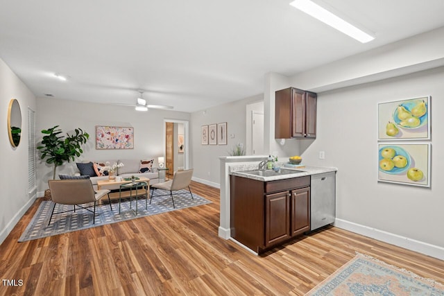 106 Choptank Ct Unit B-2, Cary, NC 27513 - kitchen featuring a sink, stainless steel dishwasher, baseboards, light countertops, and light wood finished floors