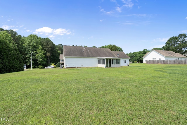 3705 Highland Creek Dr, Apex, NC 27539 - rear view of property with a lawn and a sunroom