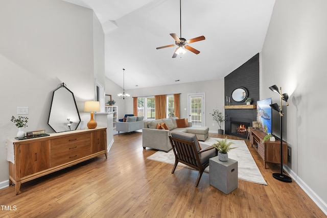 3705 Highland Creek Dr, Apex, NC 27539 - living room featuring a fireplace, ceiling fan, wood finished floors, high vaulted ceiling, and baseboards