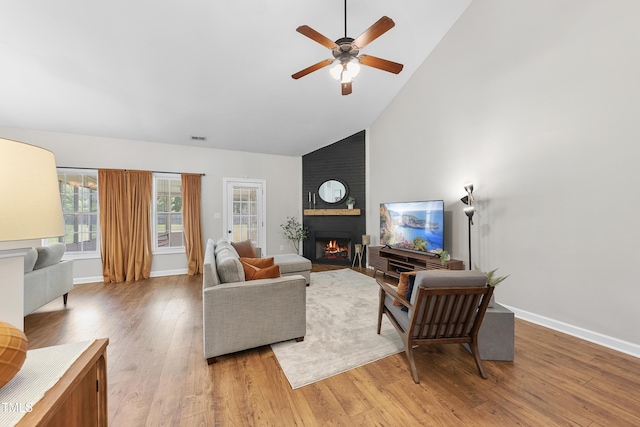 3705 Highland Creek Dr, Apex, NC 27539 - living room with a large fireplace, high vaulted ceiling, light wood-style flooring, ceiling fan, and baseboards