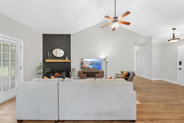 3705 Highland Creek Dr, Apex, NC 27539 - living area with ceiling fan, wood finished floors, a fireplace, high vaulted ceiling, and baseboards