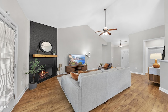 3705 Highland Creek Dr, Apex, NC 27539 - living area featuring a ceiling fan, a fireplace, lofted ceiling, light wood-style flooring, and baseboards