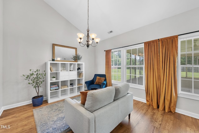 3705 Highland Creek Dr, Apex, NC 27539 - sitting room with a chandelier, wood finished floors, baseboards, and high vaulted ceiling