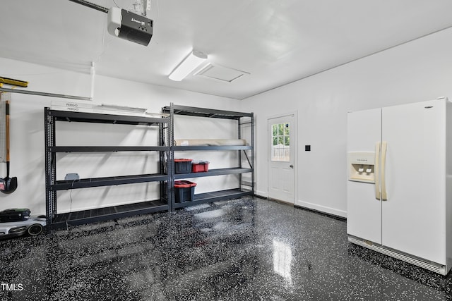 3705 Highland Creek Dr, Apex, NC 27539 - garage featuring white refrigerator with ice dispenser, a garage door opener, and baseboards