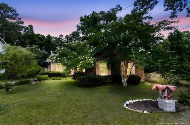 741 Ashboro St, Fayetteville, NC 28311 - yard at dusk featuring a lawn