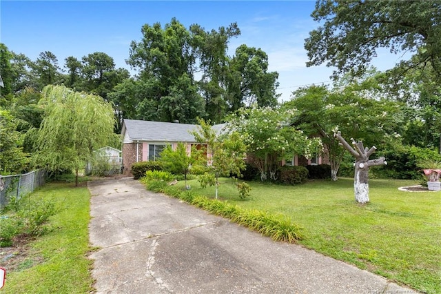 741 Ashboro St, Fayetteville, NC 28311 - view of property hidden behind natural elements with concrete driveway and brick siding