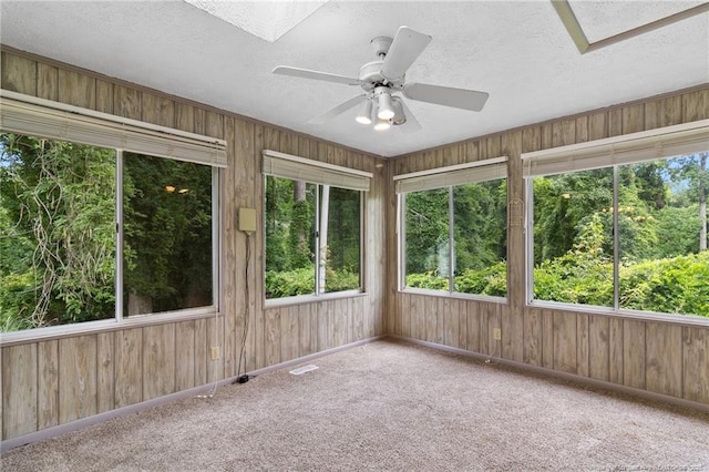 741 Ashboro St, Fayetteville, NC 28311 - unfurnished sunroom with a textured ceiling, wood walls, baseboards, and carpet floors