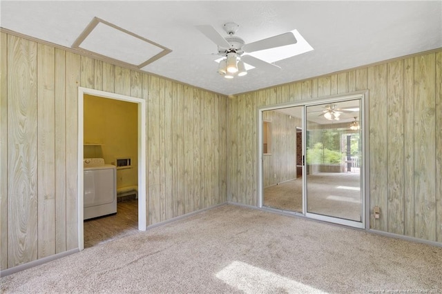 741 Ashboro St, Fayetteville, NC 28311 - empty room with washer / dryer, wooden walls, carpet flooring, a skylight, and ceiling fan