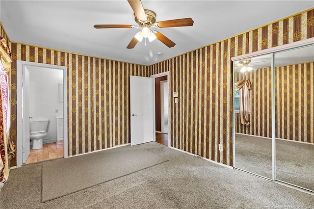 741 Ashboro St, Fayetteville, NC 28311 - unfurnished bedroom featuring wallpapered walls, a closet, ensuite bath, carpet flooring, and a ceiling fan
