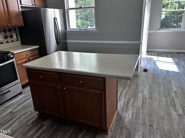 1527 Haywards Heath Ln, Apex, NC 27502 - kitchen featuring appliances with stainless steel finishes, healthy amount of natural light, and dark wood-style flooring