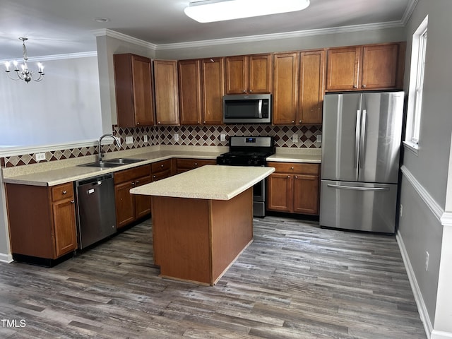 1527 Haywards Heath Ln, Apex, NC 27502 - kitchen featuring appliances with stainless steel finishes, a sink, light countertops, decorative backsplash, and ornamental molding