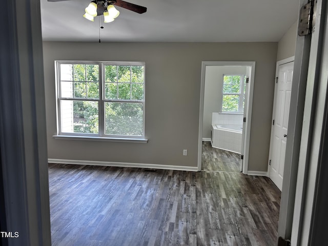 1527 Haywards Heath Ln, Apex, NC 27502 - empty room with a ceiling fan, baseboards, and dark wood-style flooring