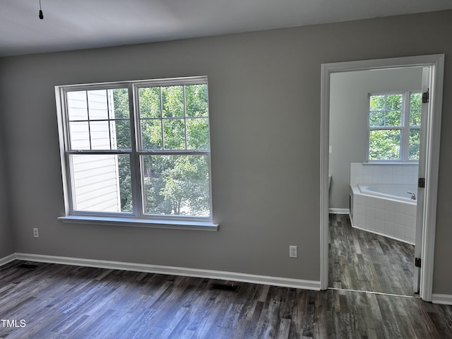 1527 Haywards Heath Ln, Apex, NC 27502 - spare room featuring plenty of natural light, wood finished floors, and baseboards
