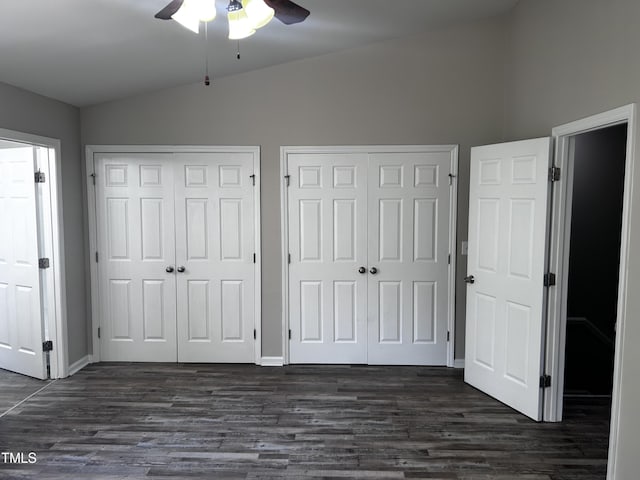 1527 Haywards Heath Ln, Apex, NC 27502 - unfurnished bedroom with vaulted ceiling, two closets, dark wood-type flooring, a ceiling fan, and baseboards