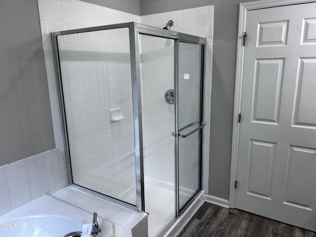 1527 Haywards Heath Ln, Apex, NC 27502 - full bath with a shower stall, wood finished floors, and a bath