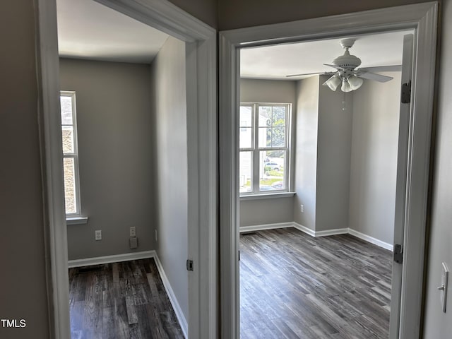 1527 Haywards Heath Ln, Apex, NC 27502 - empty room with dark wood-style flooring, a ceiling fan, and baseboards