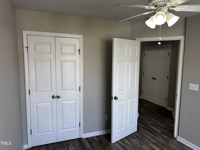 1527 Haywards Heath Ln, Apex, NC 27502 - unfurnished bedroom with baseboards, dark wood-style flooring, a closet, and ceiling fan