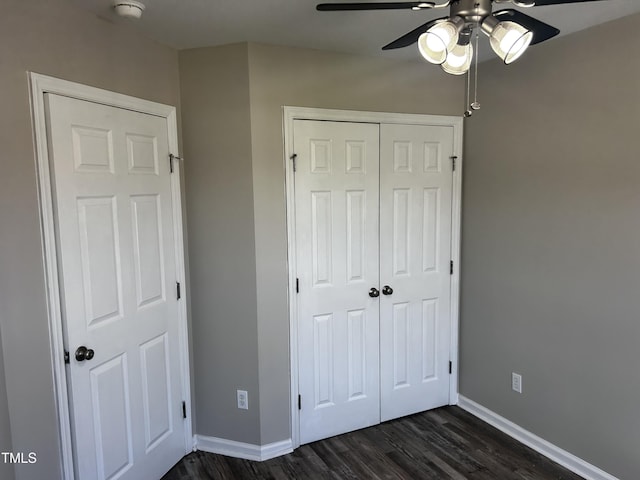 1527 Haywards Heath Ln, Apex, NC 27502 - unfurnished bedroom featuring dark wood-style flooring, a closet, and baseboards