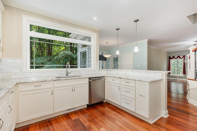 7604 Copper Creek Ct, Wake Forest, NC 27587 - kitchen featuring stainless steel dishwasher, a sink, wood finished floors, a peninsula, and backsplash