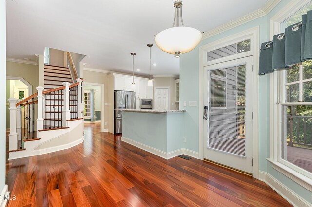 7604 Copper Creek Ct, Wake Forest, NC 27587 - kitchen featuring stainless steel appliances, dark wood finished floors, white cabinets, ornamental molding, and pendant lighting