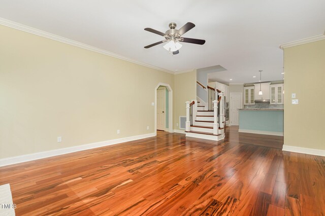 7604 Copper Creek Ct, Wake Forest, NC 27587 - unfurnished living room with stairs, crown molding, dark wood finished floors, ceiling fan, and baseboards