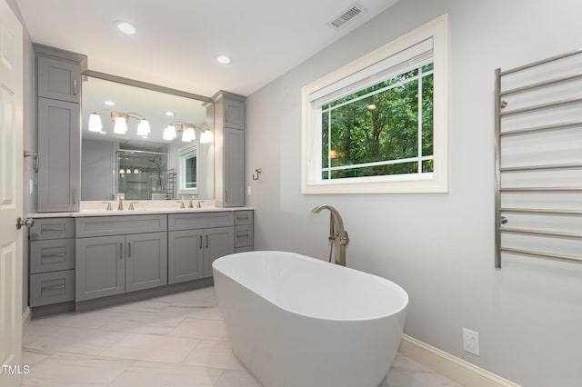 7604 Copper Creek Ct, Wake Forest, NC 27587 - bathroom featuring marble finish flooring, double vanity, a shower stall, a soaking tub, and recessed lighting