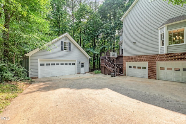 7604 Copper Creek Ct, Wake Forest, NC 27587 - view of side of property featuring stairway, brick siding, an outdoor structure, view of scattered trees, and a deck