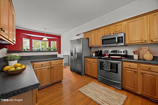 106 Oak Rd, Butner, NC 27509 - kitchen with stainless steel appliances, dark countertops, brown cabinets, and crown molding