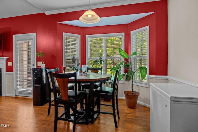 106 Oak Rd, Butner, NC 27509 - dining area with wood finished floors, baseboards, and crown molding