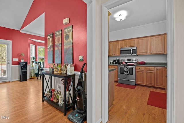 106 Oak Rd, Butner, NC 27509 - kitchen with stainless steel appliances, light wood-style floors, ornamental molding, dark countertops, and brown cabinets