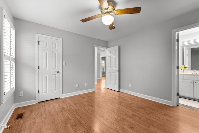 1731 Malone Rd Unit A, Burlington, NC 27215 - unfurnished bedroom with multiple windows, light wood-style floors, and baseboards