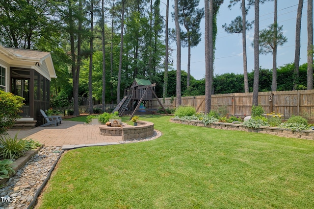 1161 Golden Star Way, Wake Forest, NC 27587 - view of yard featuring a patio area, an outdoor fire pit, a sunroom, and a playground